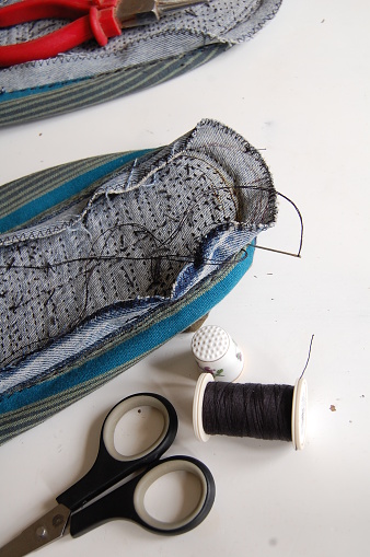 Sewing by hand making this sustainable product.