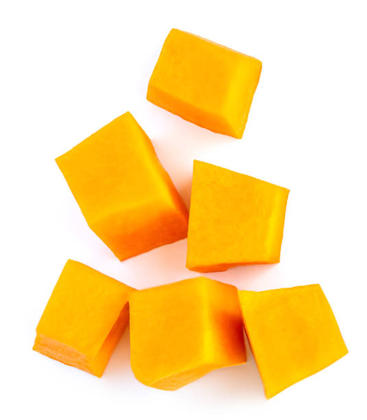istock Diced Pumpkin  isolated on white background.  Fresh Pumpkin pieces cut in a cube slice, top view. Flat lay