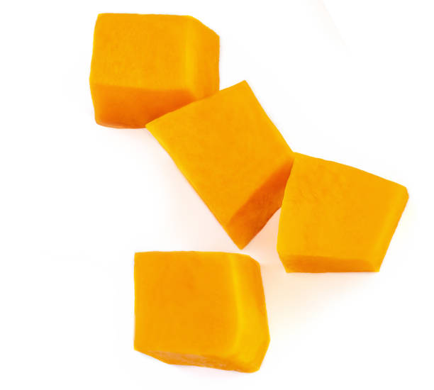 istock Diced Pumpkin  isolated on white background.  Fresh Pumpkin pieces cut in a cube slice, top view. Flat lay