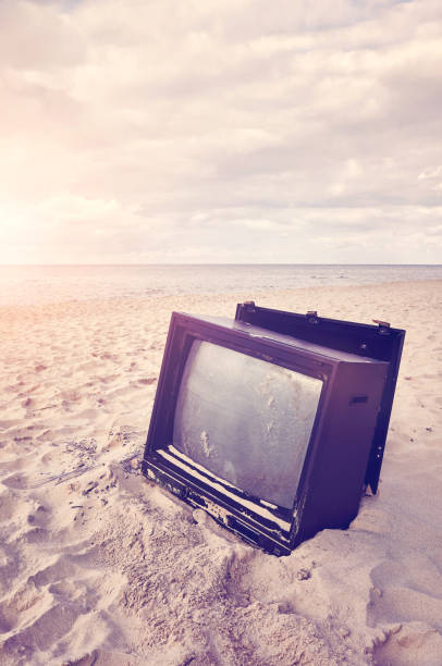 istock Old broken TV set on a beach at sunset. 1279836668