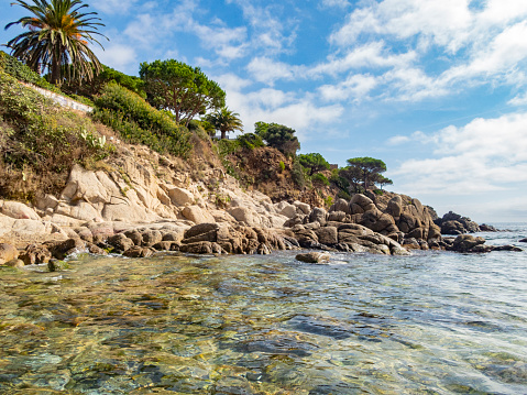 Silky turquoise water of the Mediterranean Sea and a rocky beach in Roquebrune Cap Martin, South of France near Monaco, long exposure