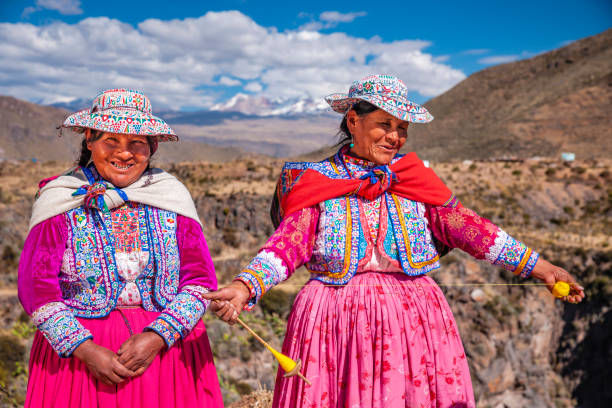 istock Peruvian women spinning wool by hand near Colca Canyon, Peru 1279838610