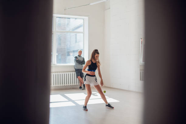 istock A young girl performs a coach's task for coordination and quick reaction under the guidance of her coach 1279840104