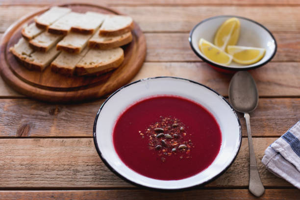 istock Beetroot soup with pumpkin seed, bread and lemon slices 1279841771