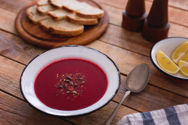 istock Beetroot soup with pumpkin seed, bread and lemon slices 1279841807