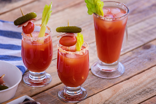 Fresh made Bloody Mary in glass on wooden table, close-up, no people