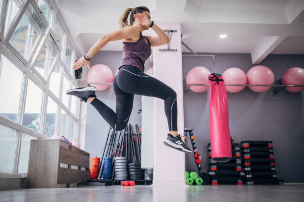 istock Young woman exercising in gym 1279844573