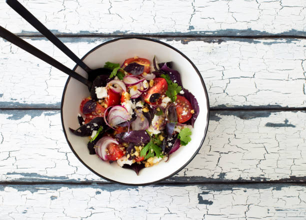 istock Fresh mix green leaves, tomatoes, soft cheese and walnuts salad 1279845191