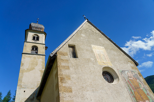 Selva di Cadore, Italy - June 29, 2020: Medieval church of Santa Fosca at Pescul, Selva di Cadore, Dolomites, Belluno province, Veneto, Italy