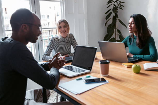 istock Three business colleagues working together in modern workspace. Brainstorming concept. 1279845257