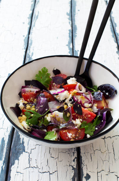 istock Fresh mix green leaves, tomatoes, soft cheese and walnuts salad 1279846783