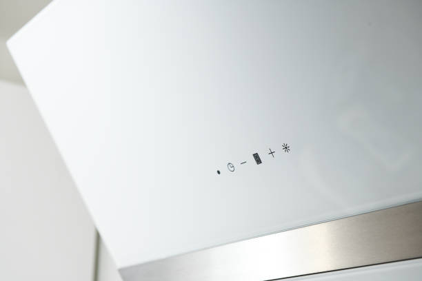 istock Close-up of a touch control panel on a white glass kitchen hood. 1279847664