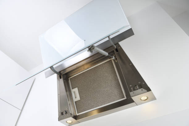 istock White inclined cooker hood. Simple light modern kitchen design.Dirty filter. View from below. 1279848062