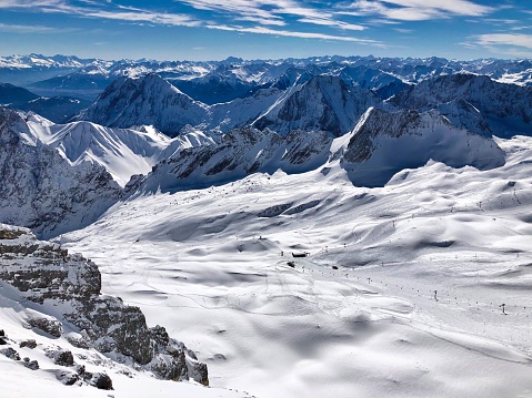 Winter view from Zugspitze (2962 m), the highest German mountain, at snowcapped German Alps and the skiing area at the glacier.