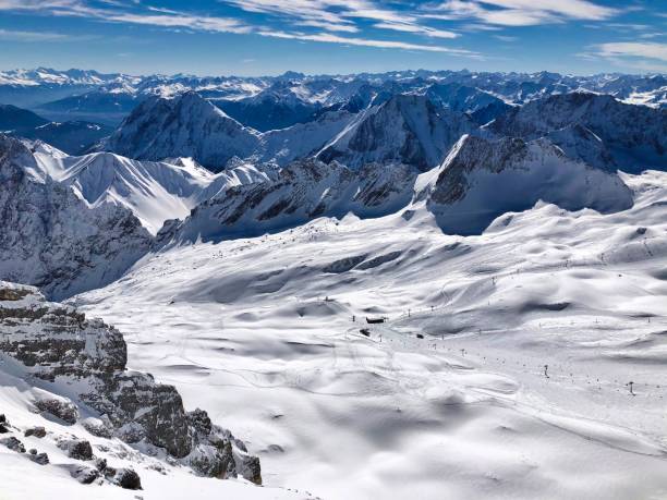 Snowcapped Alpine Peaks and skiing slopes. Winter view from Zugspitze (2962 m), the highest German mountain, at snowcapped German Alps and the skiing area at the glacier. zugspitze mountain stock pictures, royalty-free photos & images