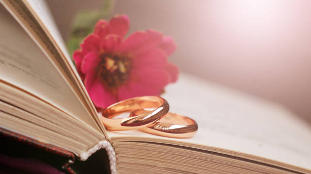 istock wedding rings, a pink flower and retro book 1279852033