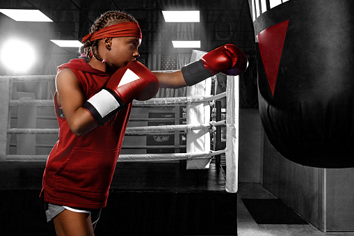 Street fighter fighting in boxing gloves. Isolated on black background with copy Space. Action shot. Sport concept.