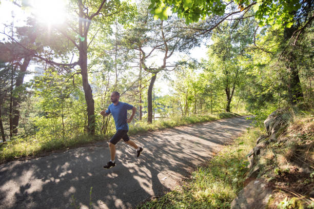 istock Man running in park during sunny summer sunset. 1279858914