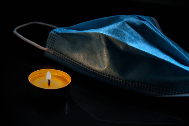 Protective medical face mask with burning candle