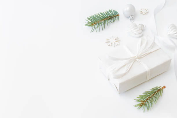 istock Frame with fir branches, christmas balls and gift box on a white background 1279859113