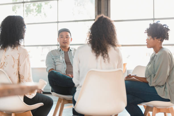istock Group of people participate in support group 1279859781