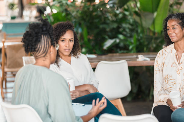 istock Counselor gives advice during group therapy session 1279859857