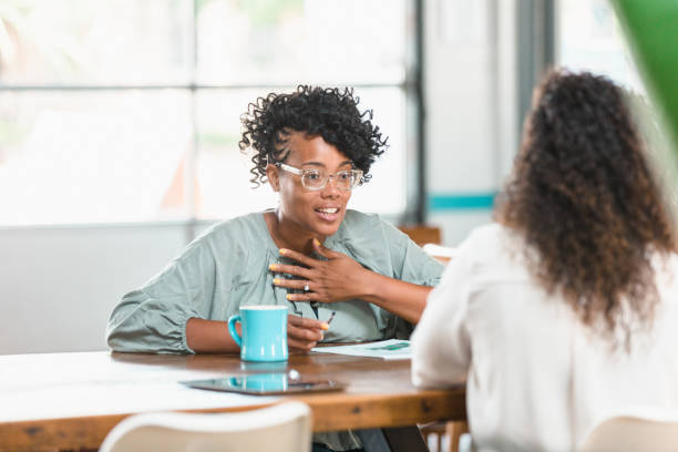 istock Businesswomen meet over coffee 1279859949