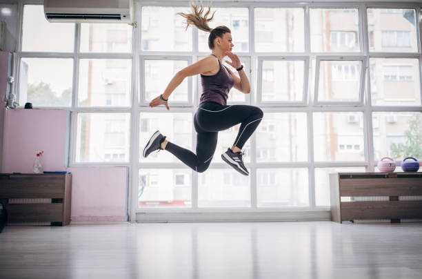 istock Young woman exercising in gym 1279861148