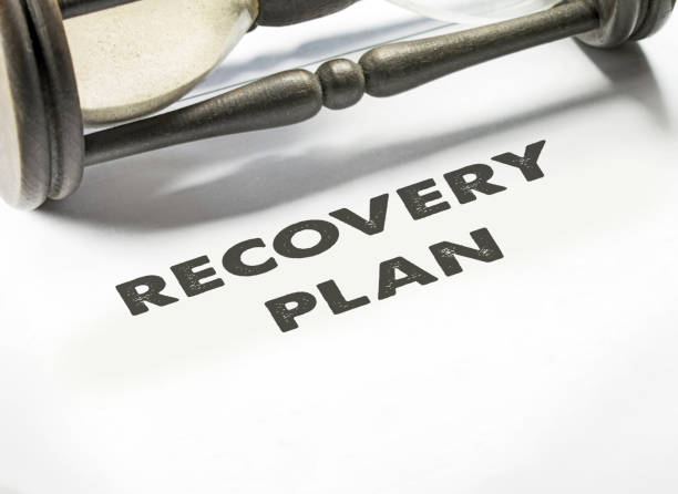 istock Disaster recovery plan with an hourglass on the background. 1279861586