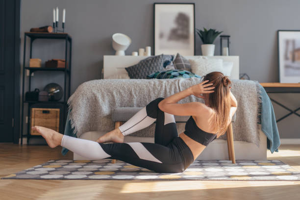 istock Fitness woman working out at home doing twists abs exercises 1279861616