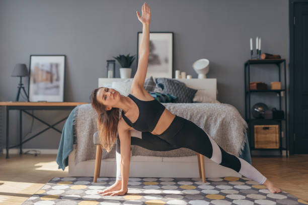 istock Athletic woman trains at home, stretching and flexibility. 1279861716