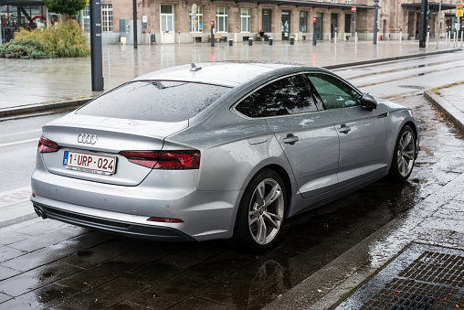 Mulhouse - France - 31 August 2020 - Rear view of grey Audo coupe parked in the street  by rainy day