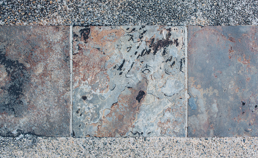 Decorative square-shaped paving tiles. Background, textures imitating natural stone.