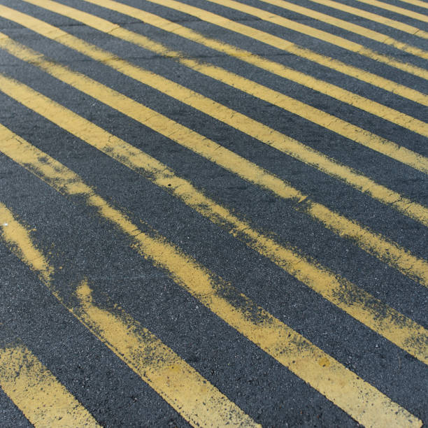 istock Frayed pedestrian crossing stripes on asphalt 1279866954