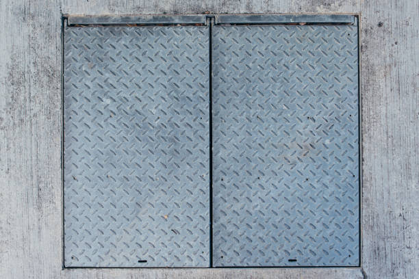 Old gray metal surface with stamped ornament.