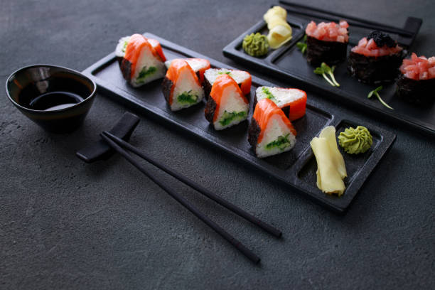 istock Seafood delicatessen sushi rolls set on plates 1279868062