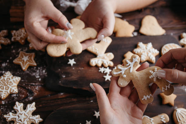 istock Friends decorating christmas gingerbread cookies 1279868102