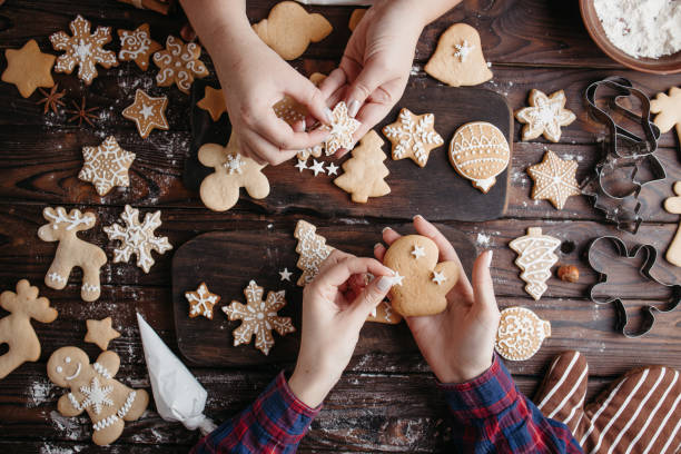 istock Friends decorating christmas gingerbread cookies 1279868116