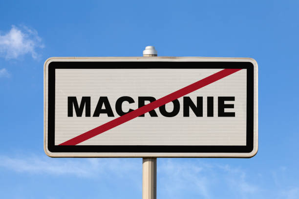 A French city sign against a blue sky indicating you're exiting \