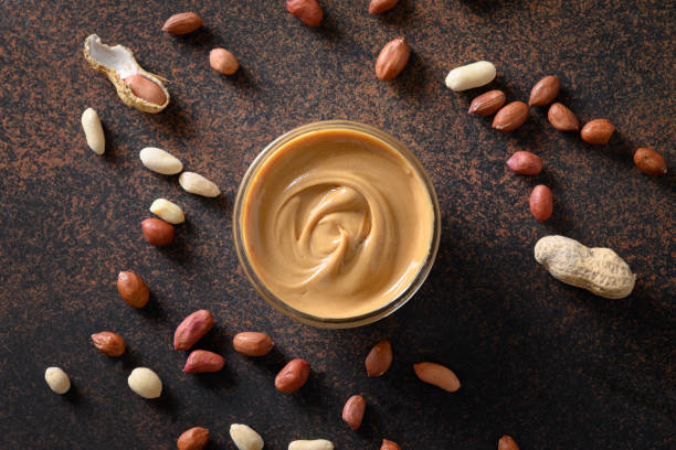istock Peanut paste on brown background for healthy nutrition concept. 1279869201
