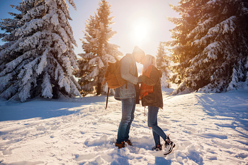 Caucasian ethnicity love couple is kissing in the mountain.
