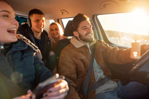 smiling, young people going on a mountain road trip - winter driving imagens e fotografias de stock