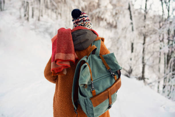 istock Unrecognizable woman with retro backpack in the cold winter day 1279873800