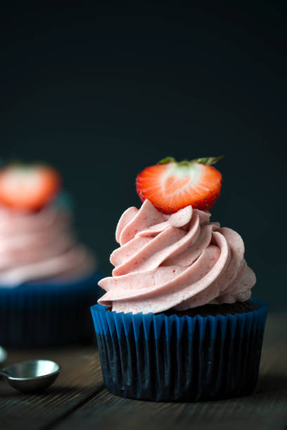 istock Chocolate cupcakes with strawberry meringue butter cream 1279875927