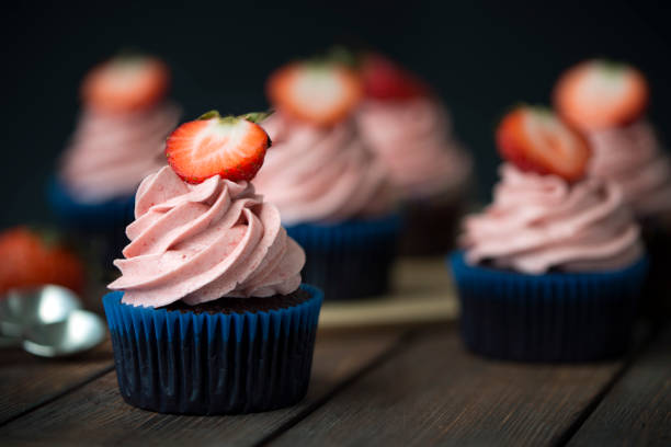 istock Chocolate cupcakes with strawberry meringue butter cream 1279875951