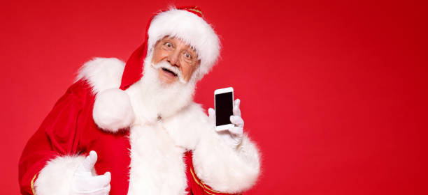 istock Real Santa Claus showing mobile phone screen 1279875960