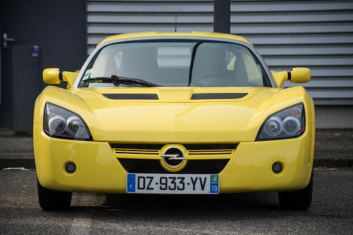 Mulhouse - France - 8 Mars 2020 - Front view of yellow Opel Speedster roadster  of parked in the street