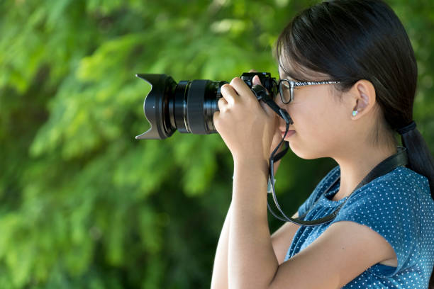 istock Girl photographer with digital camera 1279879089
