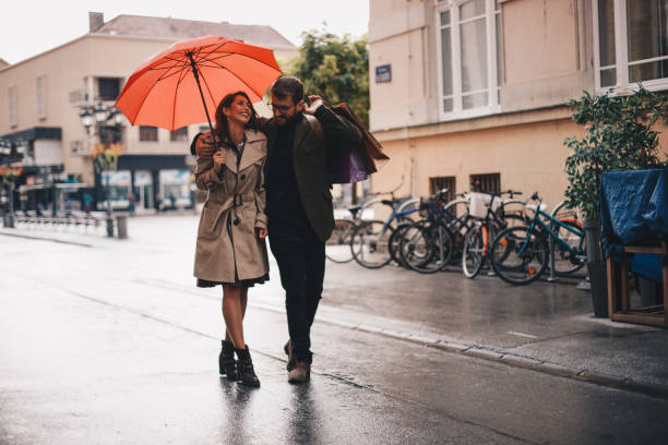 istock Young couple walking on rain 1279879093