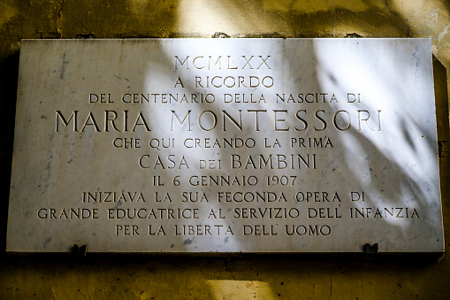 Rome, Italy - July 17, 2017: Marble inscribed tablet plaque noting the original location of the Maria Montessori school in Rome Italy
